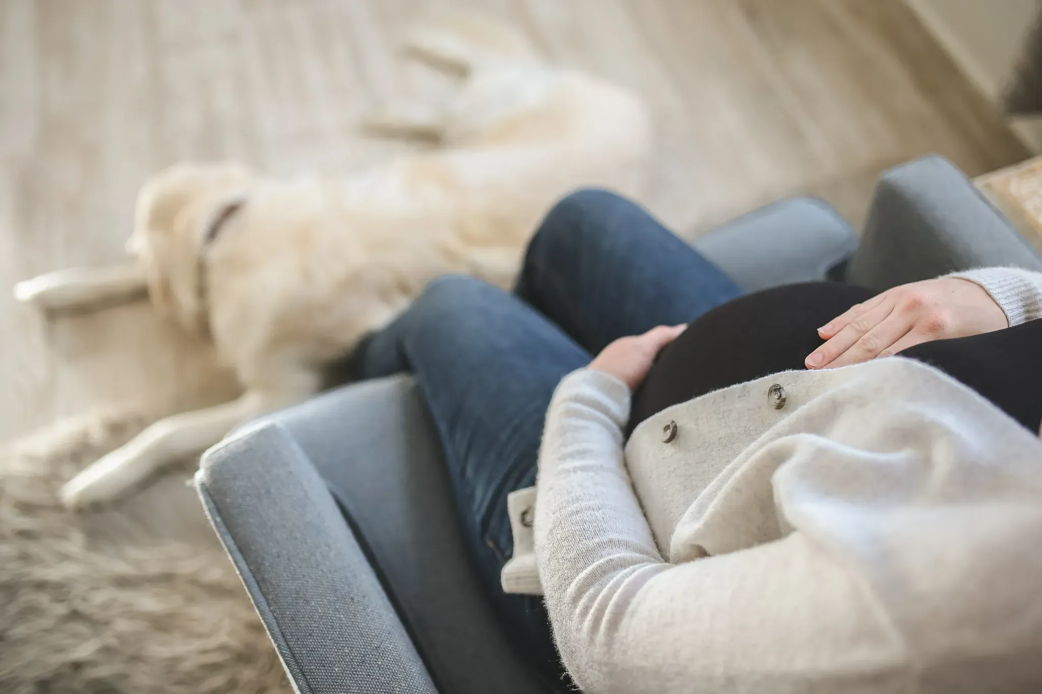 Pregnant woman relaxing at home while managing foot discomfort with custom orthotics