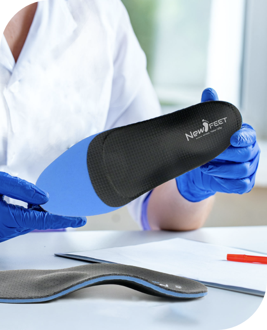 Doctor holding a New Feet custom orthopedic insole